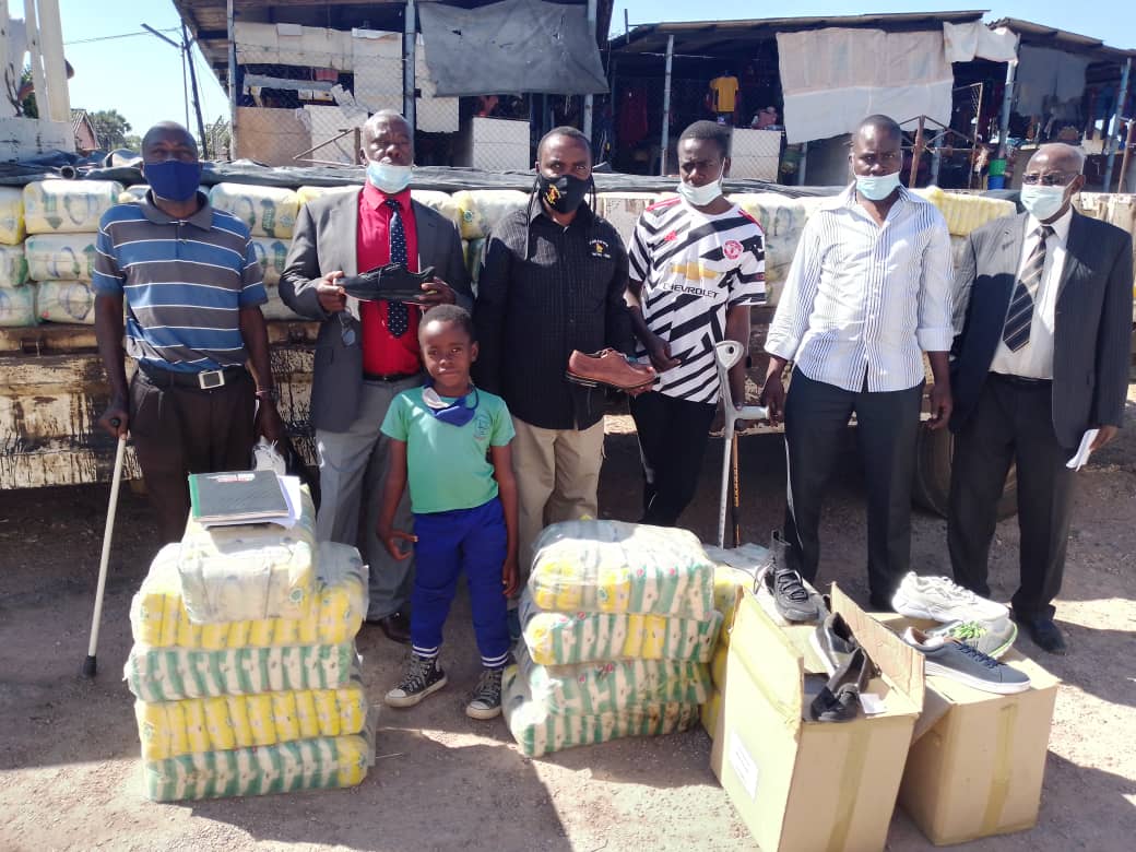 Hon Sen Dr Malinga distributing rice and shoes for the amputees at Lwendulo hall in Victoria Falls.