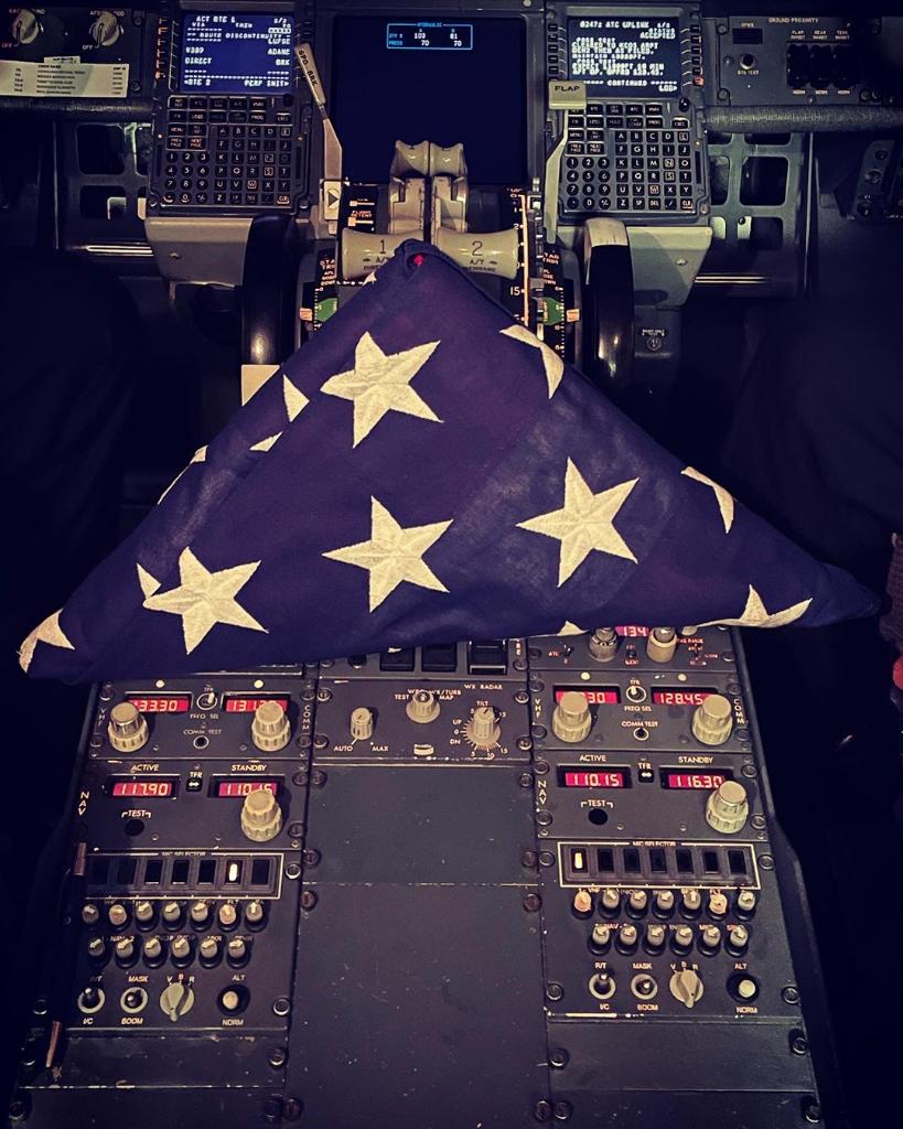 SouthwestAir's tweet photo. When our Gate Agent noticed a Customer carrying a folded flag during boarding, he learned that she was on her way home from the funeral service for her brother, a fallen Air Force pilot. After learning of her story our flight crew flew the flag in a place of honor in the cockpit. https://t.co/q5eedBLbjF