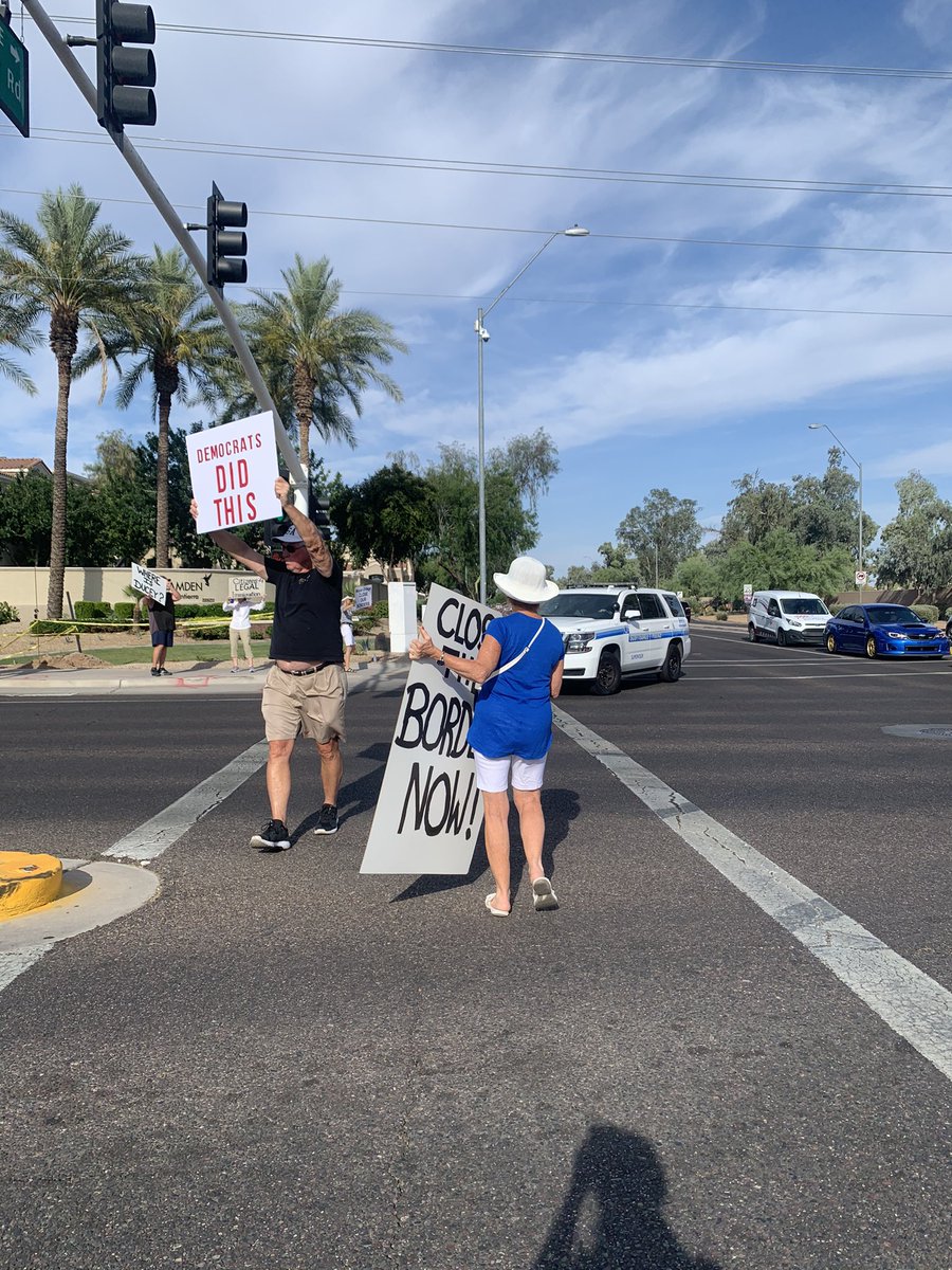 renataclo's tweet photo. Protesters are gathering in front of the former Homewood Suites hotel at Scottsdale Rd and Mountain View Rd, showing their opposition to the hotel operating as a migrant detention center. Background: https://t.co/bI5yQeSJw7 | @azcentral https://t.co/0VWWzDzhpG