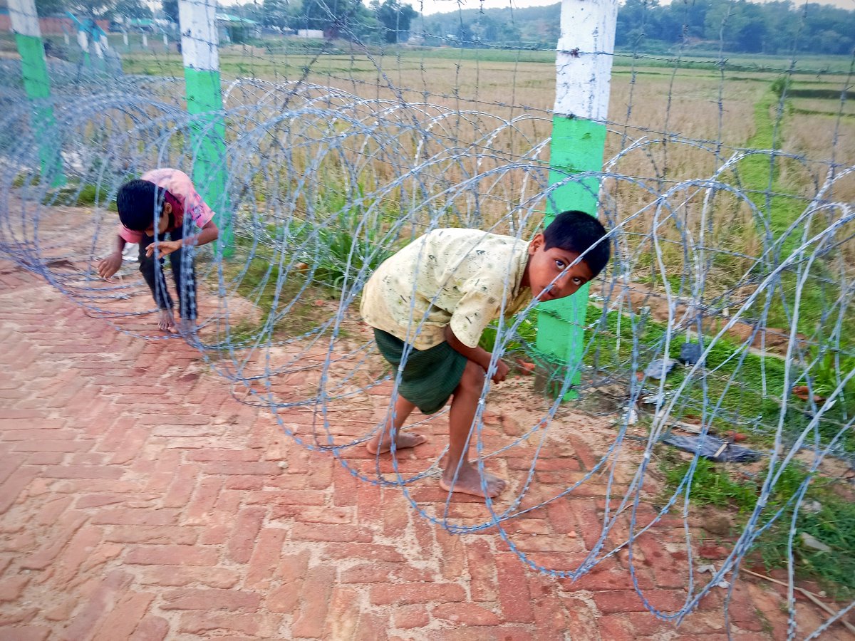 RemoveTheFence's tweet photo. #Rohingya #Refugee camp scene:

When you don’t have schools, school playgrounds or even just playgrounds, this is what happens. Children crawl into razor wire to play. We have come across several such scenes in the last few weeks. 

#RemoveTheFence #Bangladesh https://t.co/iWWsjCOodT