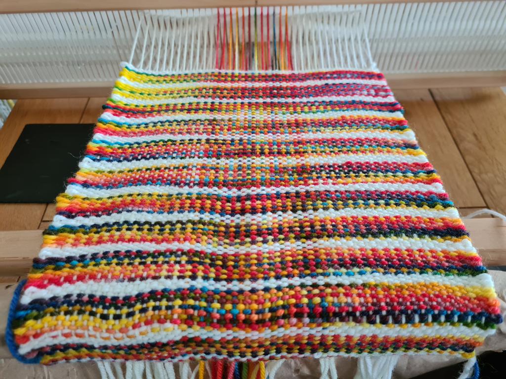 dtcrafts's tweet photo. First metre woven! A bit wonky but trying not to beat too firmly as it's for a drapy cowl. Also misjudged the meterage so need to wait until I"ve dyed up another rainbow skein before I can finish! 🙄😳 
#weaversofinstagram #weave #weaving #handweaversofinstagram #handdye https://t.co/TWqil0Kjfi