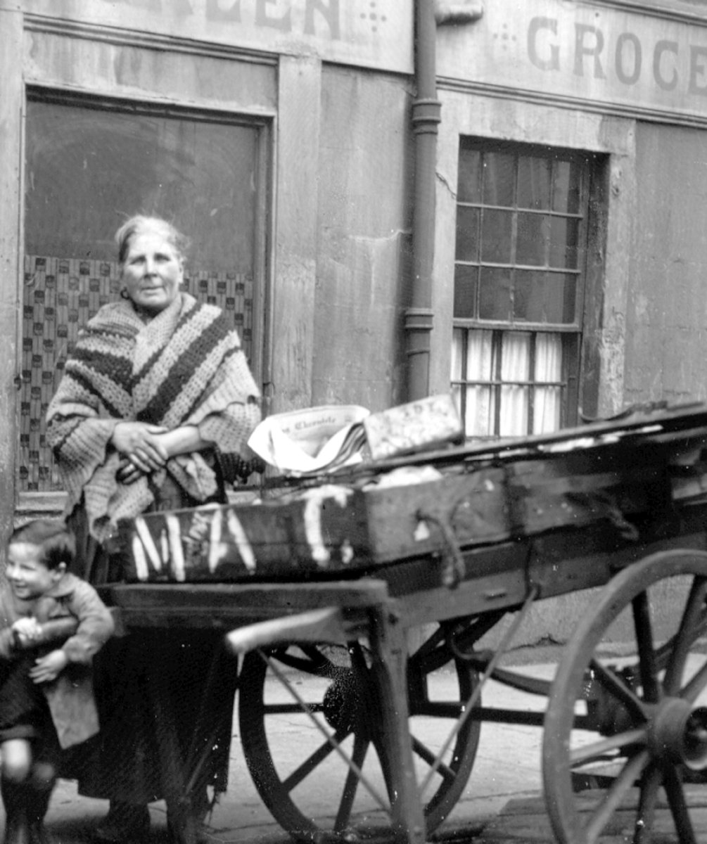 'Molly Riley': old woman in a shawl and a small boy aged 5-6, with a cart outside a grocer's shop, c.1920  Archive Ref:  D-AP 9/1/20
#Archivesathome #Glasgowlifegoeson