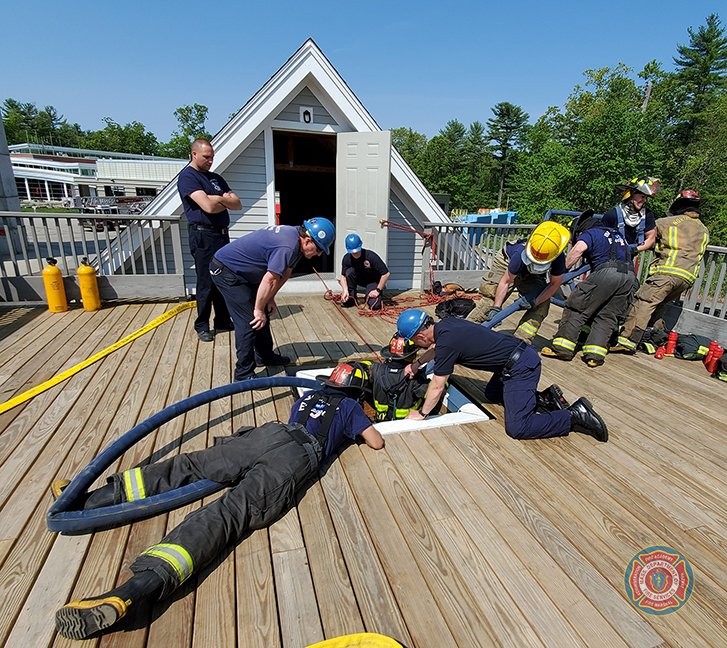 MassDFS's tweet photo. Rescuing the rescuers: #Recruits of #Class292 practice the RIT (Rapid Intervention Team) procedure, using a charged hose line to lift a “trapped” firefighter up through a scuttle. https://t.co/wK0ub0qyAK