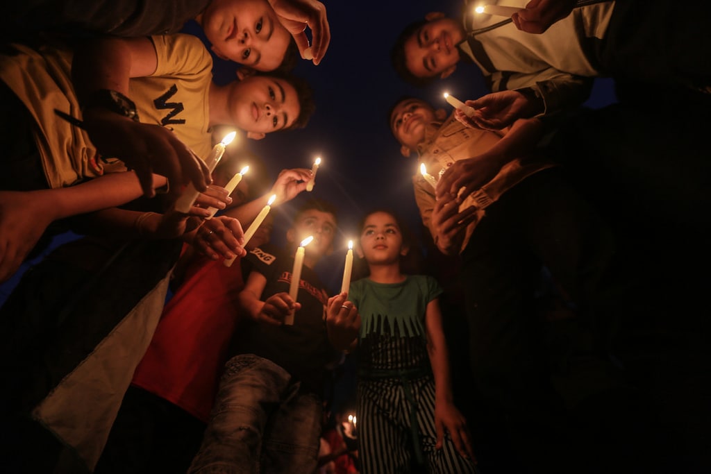 AyaIsleemEn's tweet photo. #Pictures of children standing with candles in front of the house of the "Abu Hatab" family in Gaza, which was subjected to a Zionist massacre that resulted in 10 martyrs, most of them children, and wounding others. https://t.co/Vv28j4J2HZ