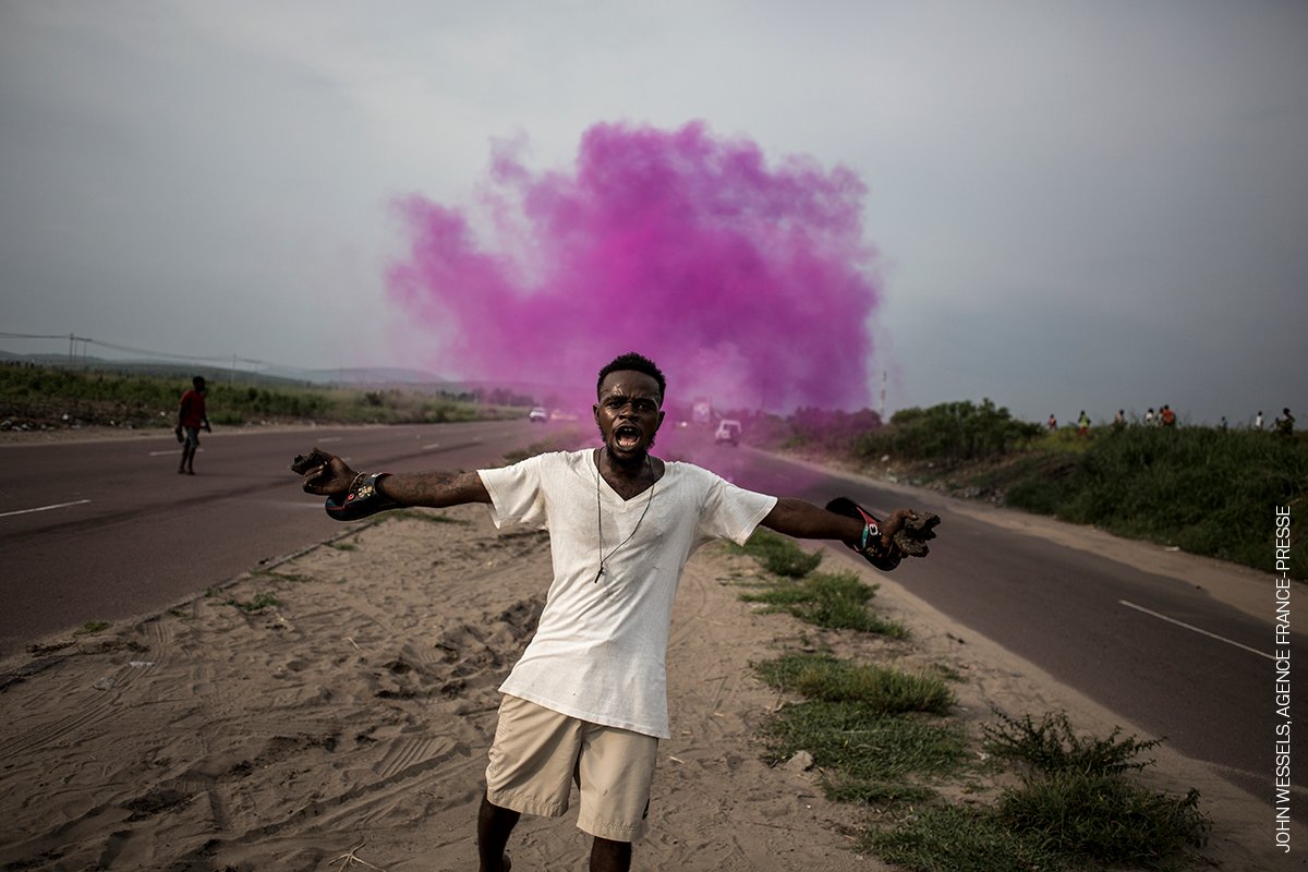 Photo of the Day | A supporter of Martin Fayulu, leader of an opposition party, runs from police tear gas in Kinshasa, DRC, December 2018. By John Wessels (<a href="/wesselsjohn1/">John Wessels</a>), <a href="/AFP/">AFP News Agency</a>, part of the special exhibition ‘#PeoplePower’. Learn more about the image: bit.ly/3otCDQa