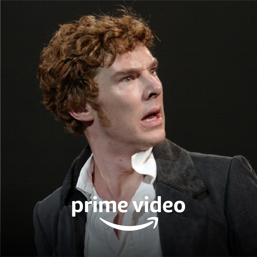 A man with light brown hair and sideburns wearing a white shirt and black coat looks shocked, over to his right. Prime Video logo.