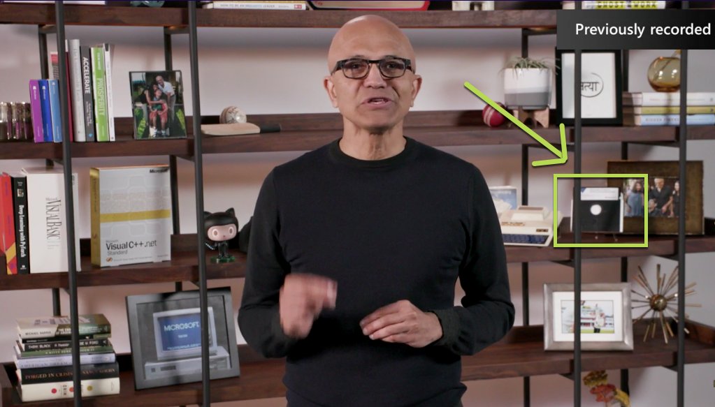 SQLRockstar's tweet photo. What is on that floppy disk behind Satya? #MSBuild https://t.co/O18GasPw87
