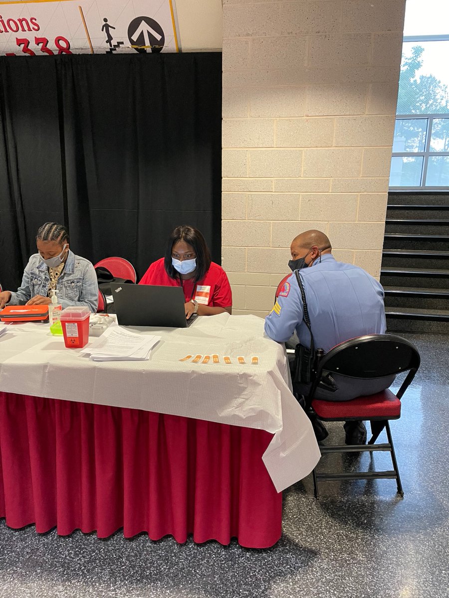WakeGOV's tweet photo. @WakeGOV at the @Canes game - protecting the protectors. @raleighpolice officer getting his COVID-19 shot. Now, if the @Canes could just get a shot on the ice to tie it up, tonight would be even better! #VaccinateWake #LetsGoCanes #BeatCOVID #BeatthePredators #StanleyCupPlayoffs https://t.co/yYwd4owkef