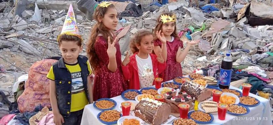 A cute girl celebrates her birthday despite her house being destroyed in #GazaUnderAttackk..