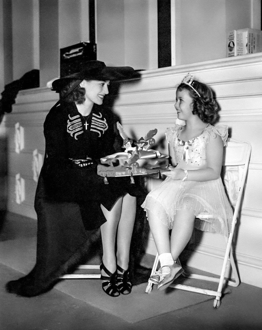 Joan Crawford visiting Shirley Temple on the set of Little Miss Broadway (1...