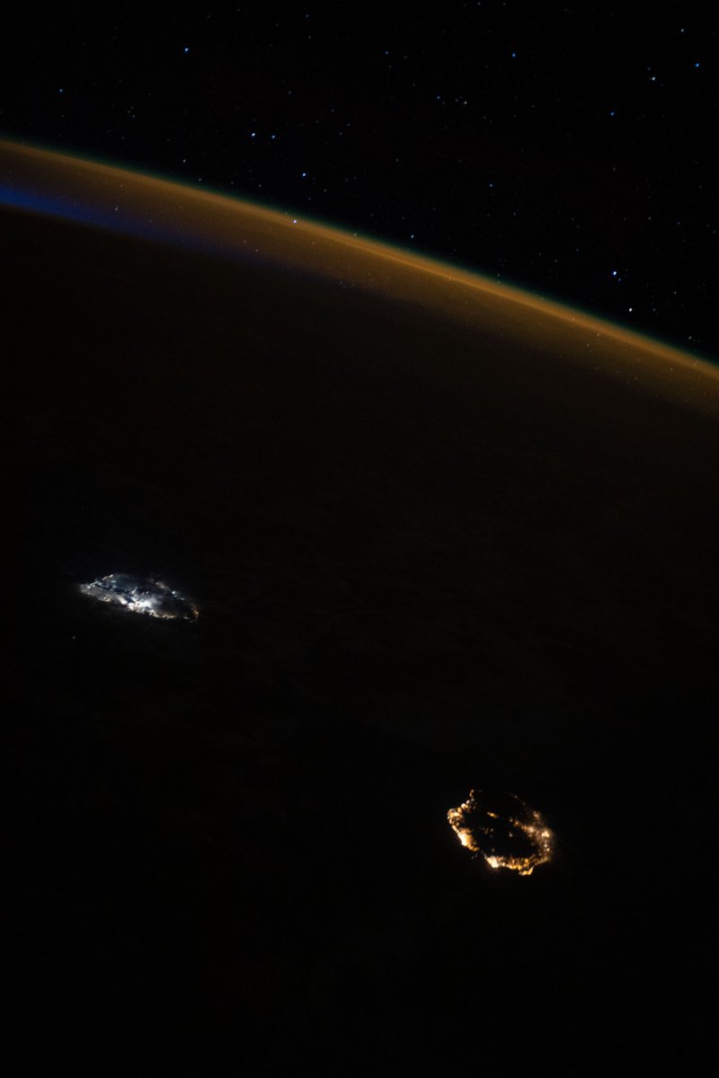 iss065e051411 (May 23, 2021) --- A starry sky, an atmospheric glow and the night lights of the island nation of Mauritius (center left) and Réunion Island (bottom right), a French department, stand out as the International Space Station orbited 265 miles above of Madagascar on its northeast Indian Ocean coast.
