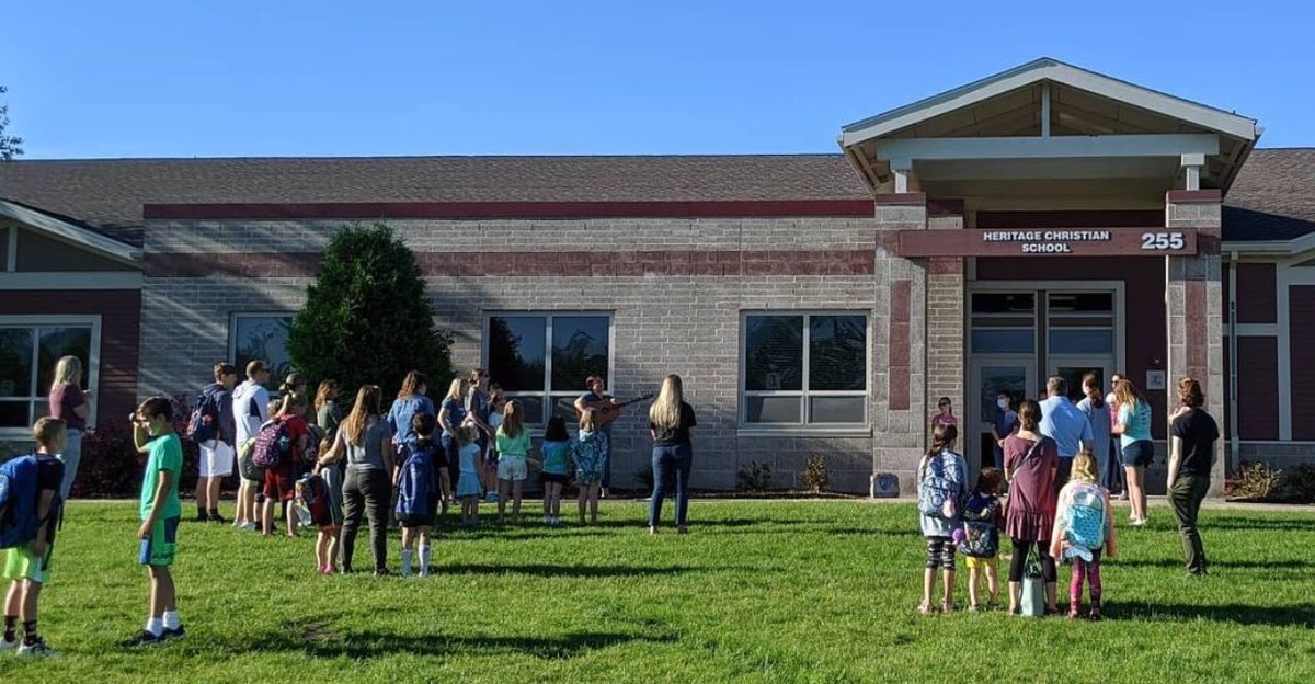 HeritageNL's tweet image. Worship Wednesday! On this last Wednesday of the school year, our staff held our morning prayer/worship on the front lawn as students and families arrived. It was good to gather and give thanks for all God has blessed us with this year. #HCSTransform