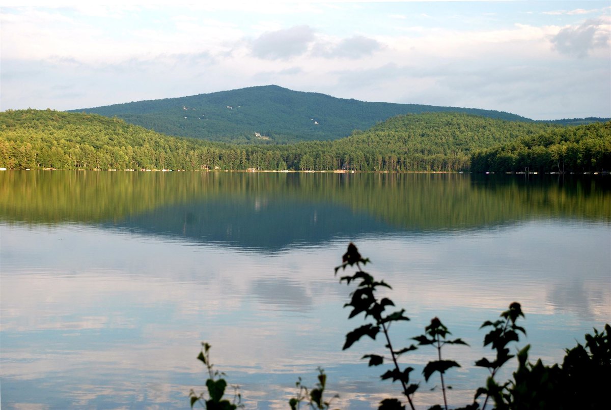 A rare find on quiet, crystal-clear Rust Pond! Set just steps from the ...