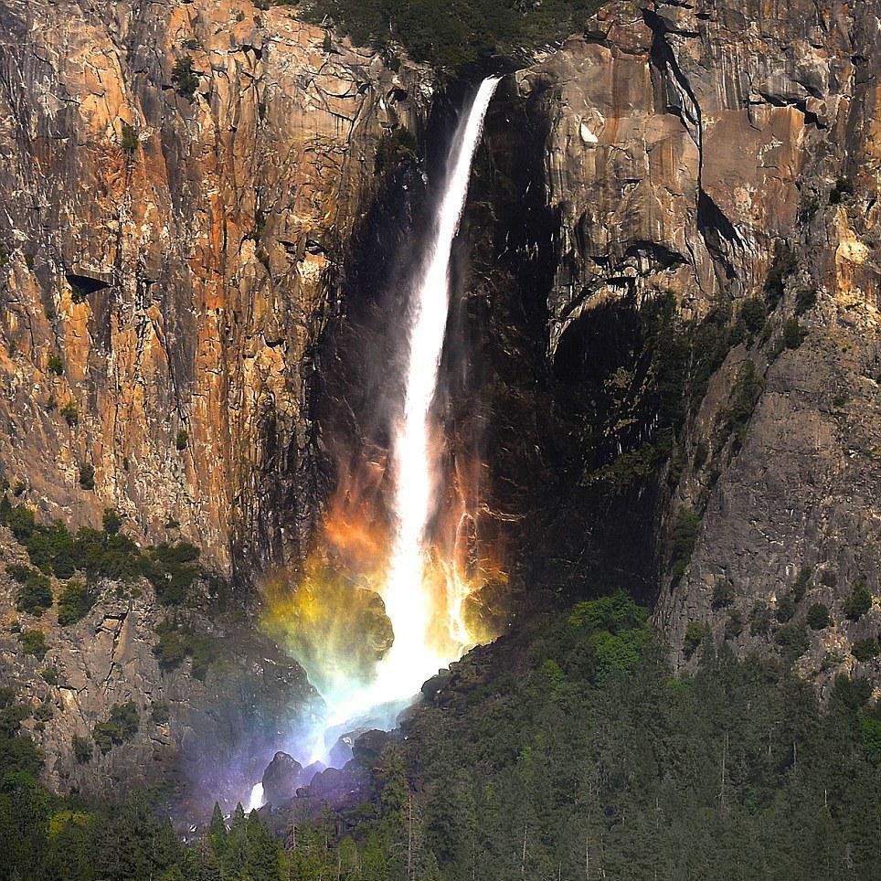 A rainbow forms on the Waterfall in Yosemite