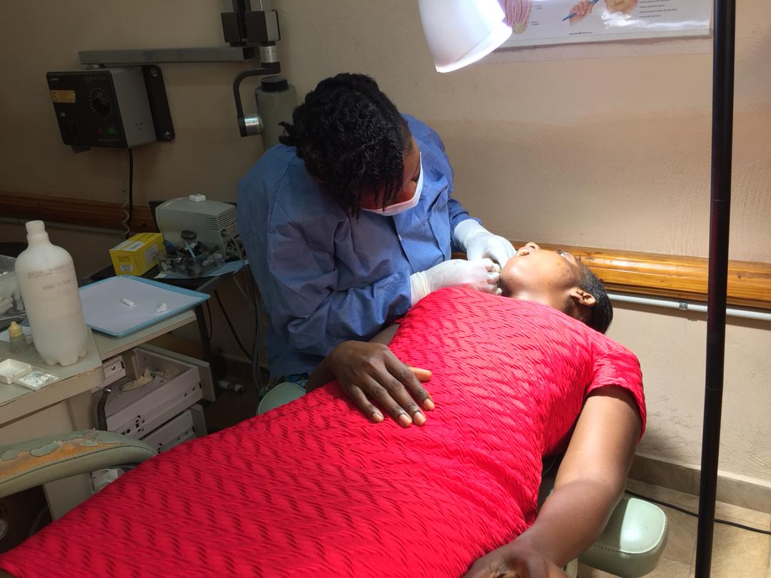 Mission_of_Hope's tweet photo. Dr. Mabou gently treats Fabienne for gum disease in the dental clinic at MOHI. https://t.co/kgFmpTNxuy