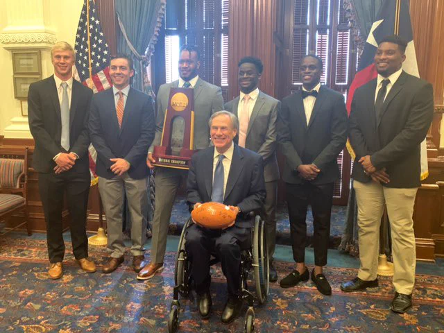 Sam Houston football team and governor Abbott.