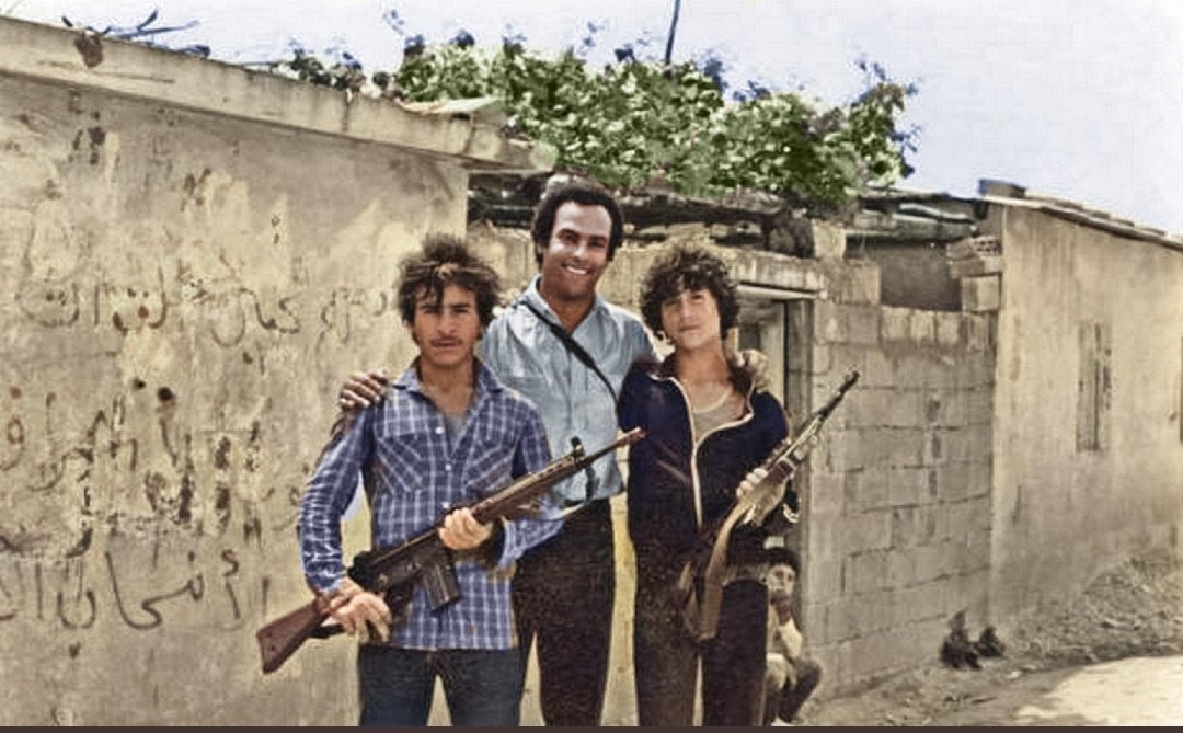 Huey P. Newton co-founder of the Black Panther Party with Palestinian resistance fighters outside an unnamed refugee camp in Lebanon, 1980