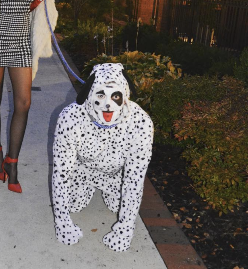 Hockey Player TJ oshie on all fours in a truly horrifying dalmatian costume that looks like a huanted doll.