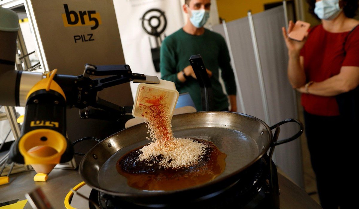 Chef Maria Munoz watches as a robot created by Spanish companies br5 and Mimcook makes paella during a demonstration at a warehouse in San Fernando de Henares, outside Madrid, Spain
Credit: REUTERS/Susana Vera

<screams>