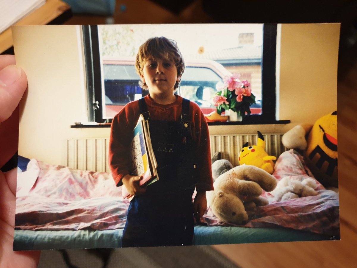 ItsRobinHoot's tweet photo. Mini-Robin circa anno 2000. Wearing Bob The Builder overalls and holding my precious Garfield cartoons. #WhatALook https://t.co/shoSl13RMe