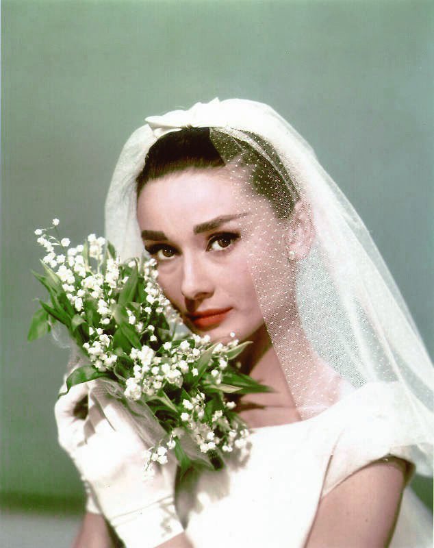 audrey hepburn holding a bouquet of lily of the valley while wearing the famous wedding dress designed by hubert de givenchy for 'funny face', 1956 audrey hepburn holding a bouquet of lily of the valley while wearing the famous wedding dress designed by hubert de givenchy for 'funny face', 1956