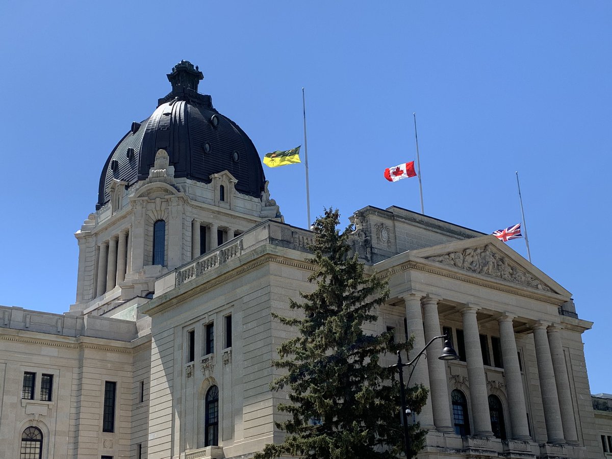 PremierScottMoe's tweet photo. The flags at the Saskatchewan Legislature are being flown at half-mast to honour the 215 Indigenous children whose remains were found at the site of the former Kamloops residential school. https://t.co/rI0yXzJXmw