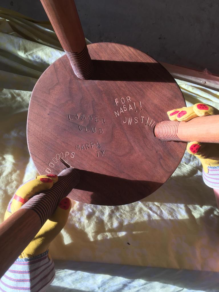 Inscriptions underneath the stool. 