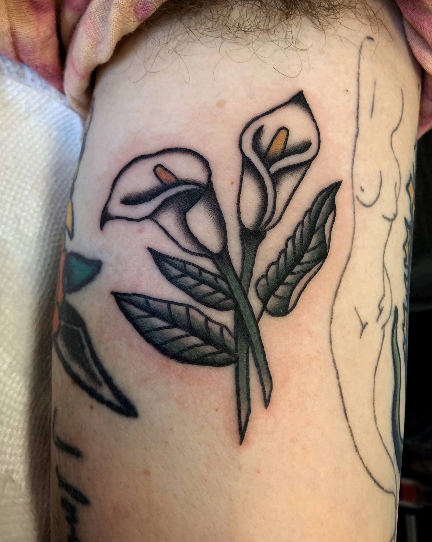 Minimalistic style one line calla lily tattoo located