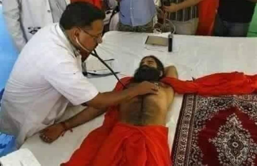Baba Ramdev treating this poor doctor's ears with his heart