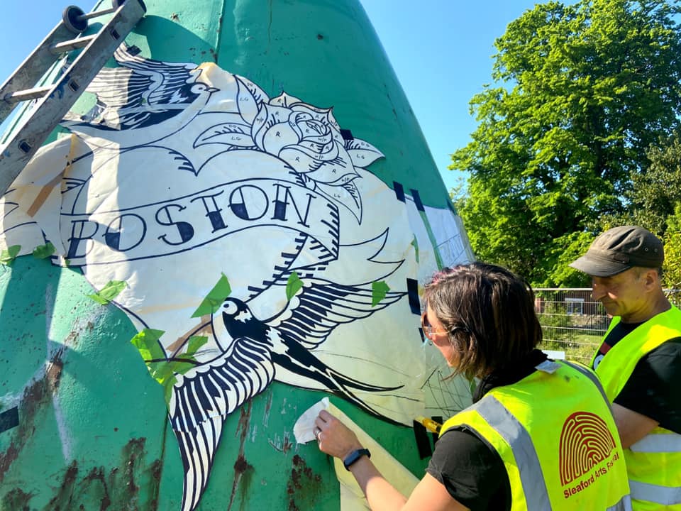 TransportedArt's tweet photo. @carriereichardt and her team are here in Boston! 

The mosaics are being put on two of the buoys. Here's the work being done today on the buoy at St Botolph's footbridge. https://t.co/4VgkuVdC2W