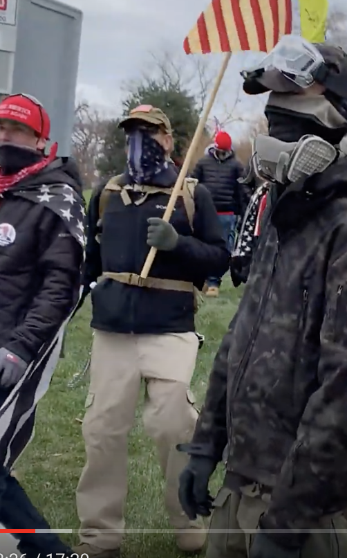 erica1933's tweet photo. NEW HASHTAG: #BumbleBetsy
With #BumbleGoggles #VirginiaSnap, holds B Ross flag. They seem to signal people to move on NW side then go E to where Joe Biggs emerges. See chain on R pocket.
https://t.co/HZBH9WovsD
#SeditionHunters @capitolhunters @SeditionHunters @TwittsnTweets https://t.co/cV1BwJREps