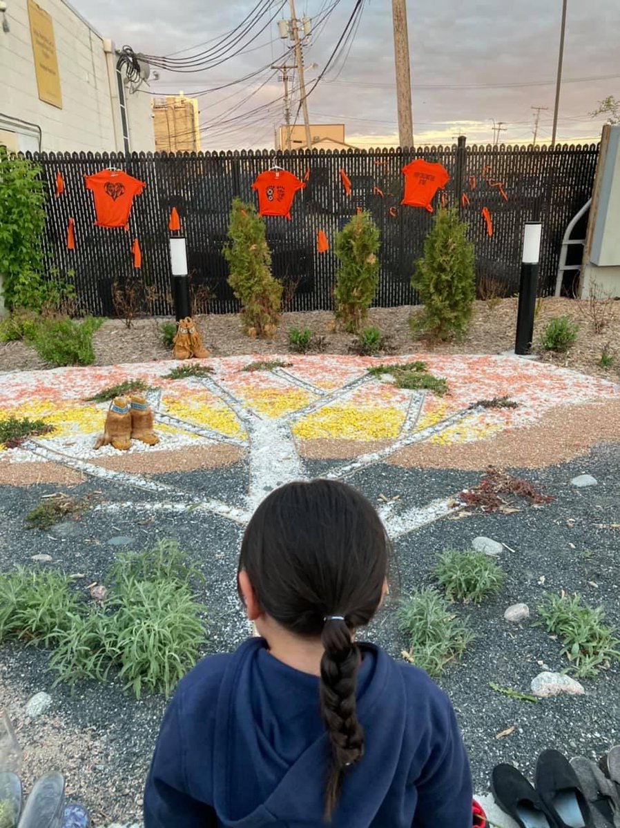 Jesse, grandnephew of Jacqueline Bercier - Indigenous Student Centre teacher at the Comp - looks on and pays his respects at the Medicine Garden on Manitoba Avenue. Here he witnesses Orange shirts hung on the fence and the 300 little.. lssd.ca/_layouts/15/ci…
