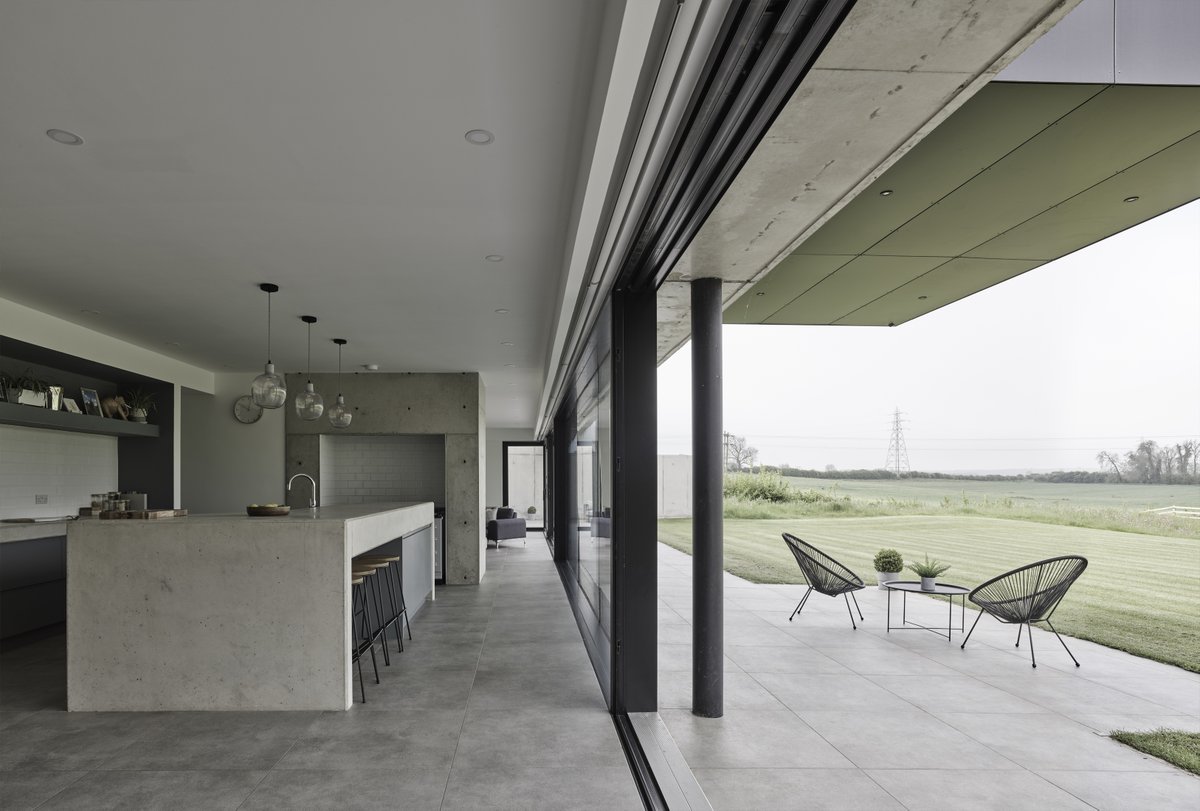 It was great to be back out at our award winning Barrow House project last week photographing the internal spaces.  
 
The concrete chimney creates an elegant divide between the open plan kitchen, dining and living room and formal lounge beyond.