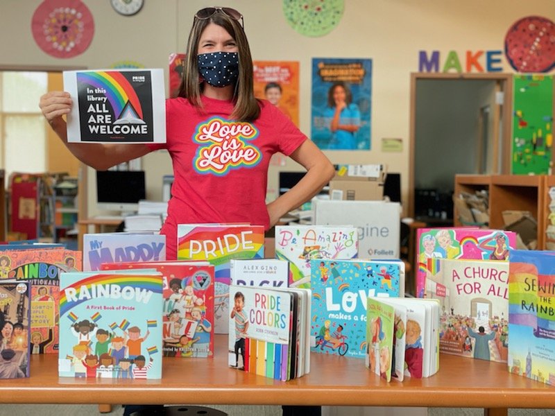 NorthsideES's tweet photo. It's Pride Month and #NavigatorNation is celebrating and lifting up love throughout our school community. Check out @KatColeReads and all the great happenings in the @NESlibrary 🧡💙🧡💙 #NavigatorNation #NavigatorPride #PrideMonth @chccs @csharpless1 @APJonesNES https://t.co/OHz7yE9yWk