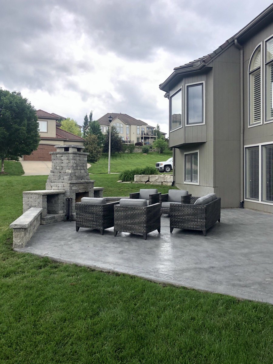 This Lenexa #backyard has a glowing, new focal point - the Fremont #fireplace! Built-in #benchseating and #firewoodstorage ensure that the #patio will be warm and inviting all year round.