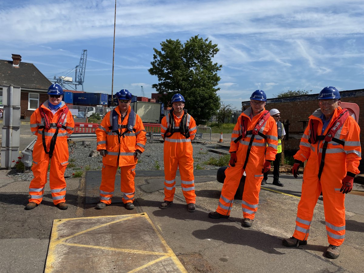 Simon Hawkins, area director for East Anglia, standing beside other staff members in orange high vis on site at the Port of Tilbury.