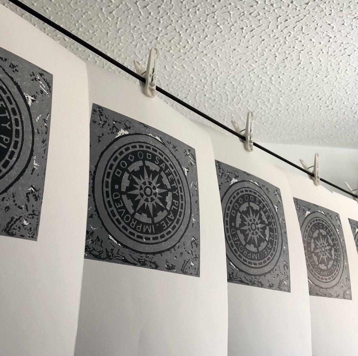 sjohndavey's tweet photo. Manhole cover no. 1 is finished and drying…I went for a dark grey for the second colour, not black - think that was a good decision. 

And now I sense more manhole cover prints on the horizon.

#manholecover #manhole #linoprint #linocut #printmaking https://t.co/xHWE4pTD6B