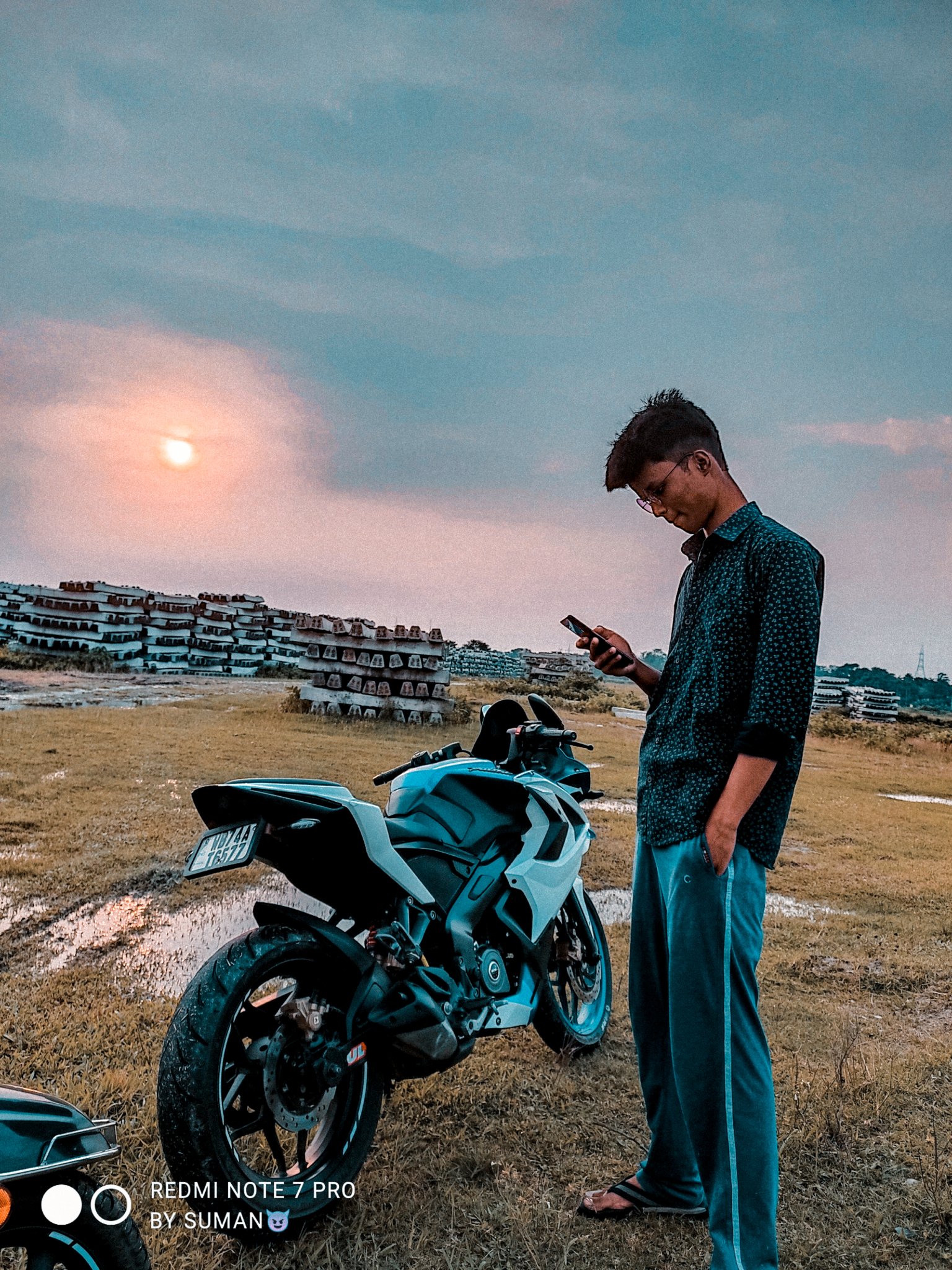 Boy posing on the Pulsar bike - PixaHive