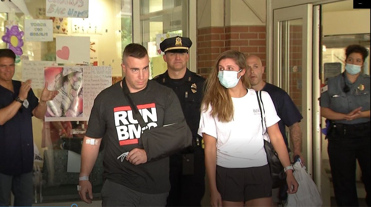 JUST IN: Ofc Matthew Donaghue leaves Boston Medical Center with a sling on his left arm and bandages on his right arm and hand after being wounded in shootout on Friday. He is accompanied by his wife and applauded by his fellow officers and Braintree's mayor. #wcvb