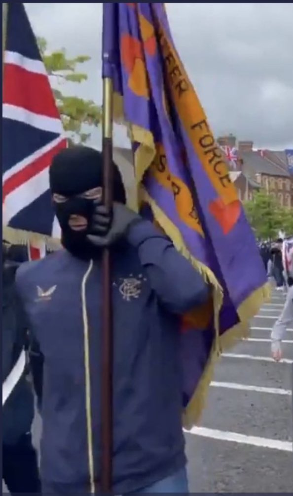 chrisadonnelly's tweet photo. Doug Beattie’s attendance at this illegal rally, led by balaclava-wearing loyalists, implicitly endorses the ‘long hot summer’ campaign aiming to manufacture division &amp; instability using the band parade culture across NI.

That’s not leadership. https://t.co/q3IFmMKgyp