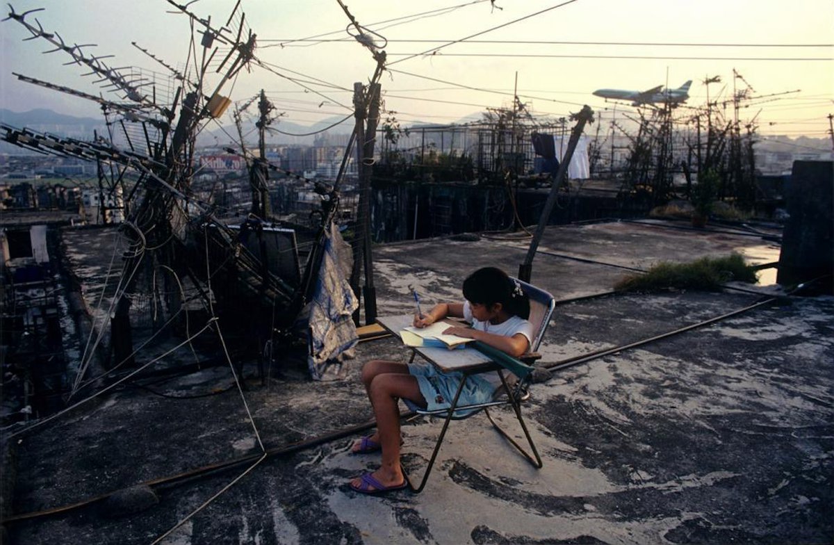 rabihalameddine's tweet photo. Greg Girard, student doing homework on walled city [Hong Kong] rooftop, 1989 https://t.co/UgHWepFGvs