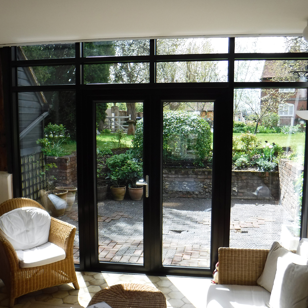 Our team loved working on this assignment because it was a technically difficult project and they relish a challenge!

It involved them installing aluminium French doors and curtain walling in RAL 9005 Matt Black at a listed barn in Beaconsfield, Buckinghamshire.