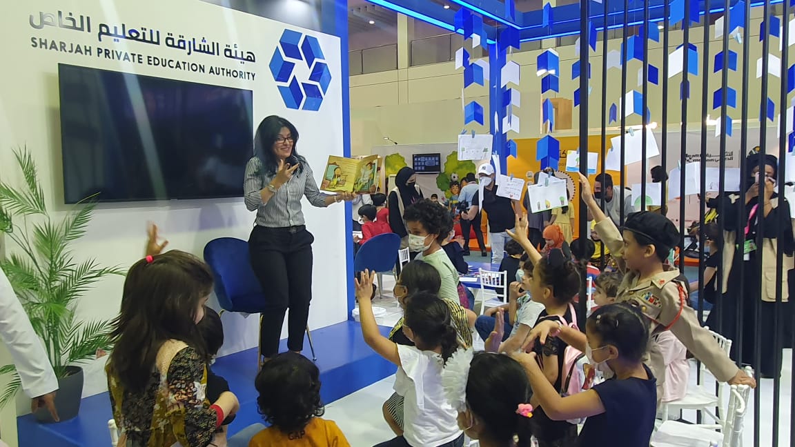 AIS_SchLibrary's tweet photo. Our very vibrant school librarian, Ms. Nawal, reading an Arabic book to a group of young readers at the Sharjah Children's Reading Festival. هيئة الشارقة للتعليم الخاص @SharjahBookAuth  
#AISSchLibrary #AISReading #AISCommunity https://t.co/JzRtSDZz9g