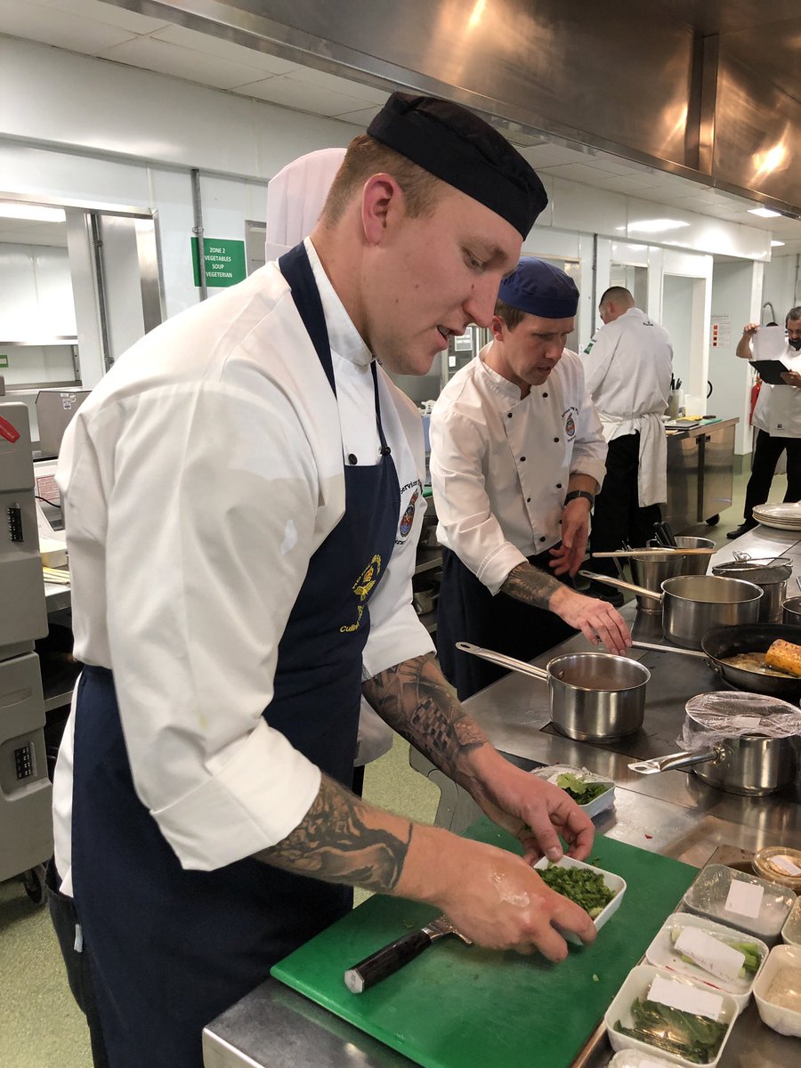 TildaChef's tweet photo. Alex and Neal from the @RoyalAirForce getting well and truly stuck into their dishes! We can’t wait to taste them! #TCTOTY @SalonCulinaire #SalonCulinaire @Craft_Guild https://t.co/eV0G2pnsje