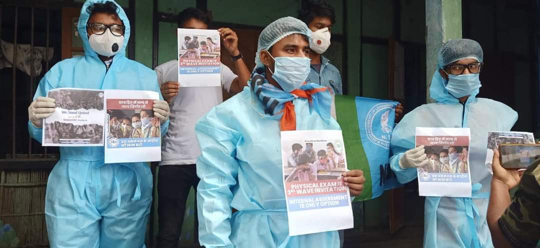 NSUIAssam's tweet photo. Today, Barpeta @NSUI unit protested against the offline examination of SEBA/AHSEC Board amid COVID-19 wearing #PPEkits. We demand immediate cancellation of 10th/12th board examinations in view of rising COVID cases ! 

#CancelAssamBoardExams https://t.co/NVYfWzSctQ