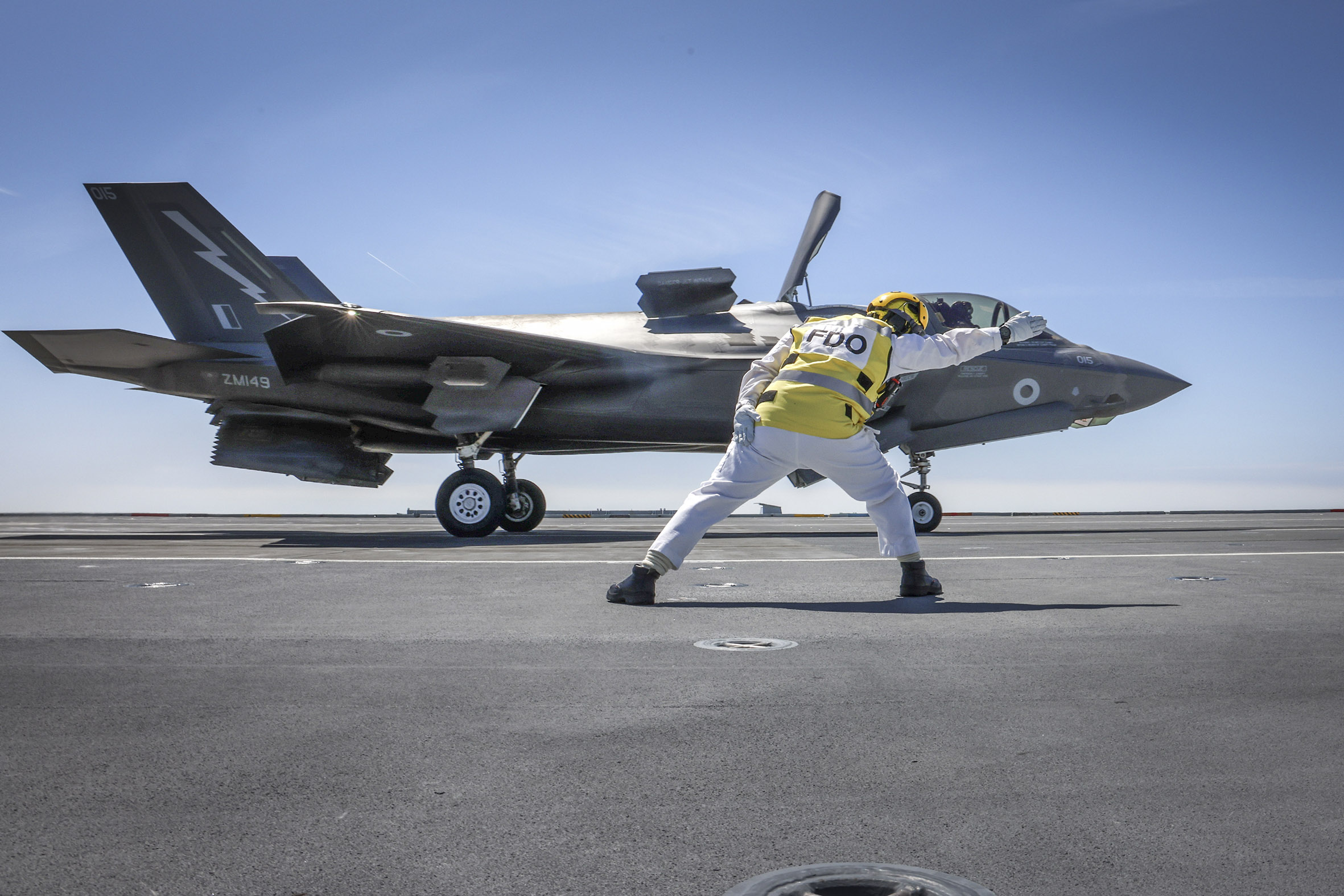 Go for launch - Flight Deck Officer Lieutenant Graham Blick gives the first launch of an F-35 the go-ahead