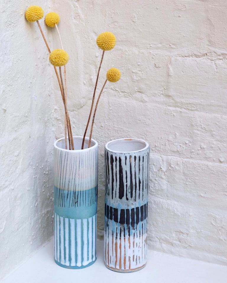 Two gorgeous new additions to Caroline Nuttall-Smith's collection of one-off cylinder vases, which can stand alone or work beautifully in groups. Caroline uses abstract marking and print techniques, then matt/shiny glazes and wax resist to stunning effect madebyhandonline.com/collections/ca…