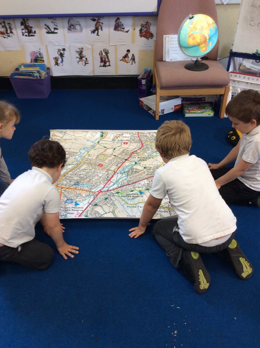 Looking at maps of Bridport to inform the alien where it has landed.