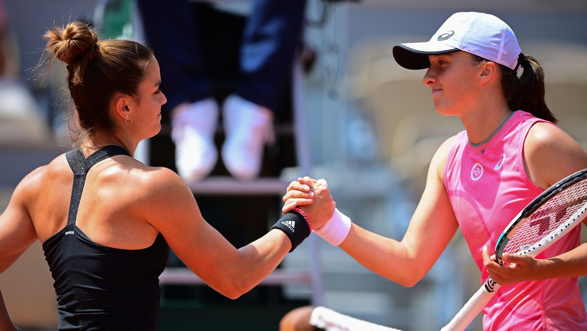 Greece's Maria Sakkari (L) and Poland's Iga Swiatek shake hands at the end of their women's singles quarter-final tennis match on Day 11 of The Roland Garros 2021 French Open tennis tournament in Paris on June 9, 2021.