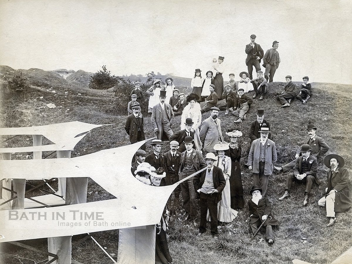 Onlookers pose next to an experimental plane in 1902.  The photo was taken up on Lansdown a year before the first recorded flight by the Wright Brothers.